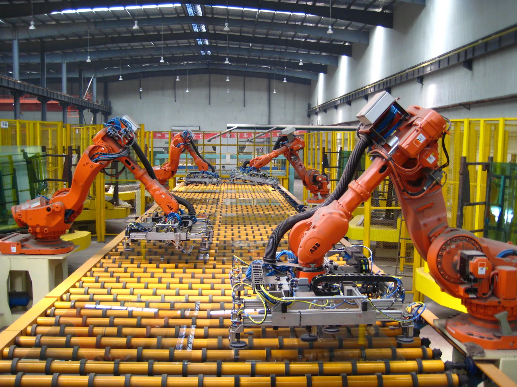 Robotic handling of float glass sheets on an industrial production line