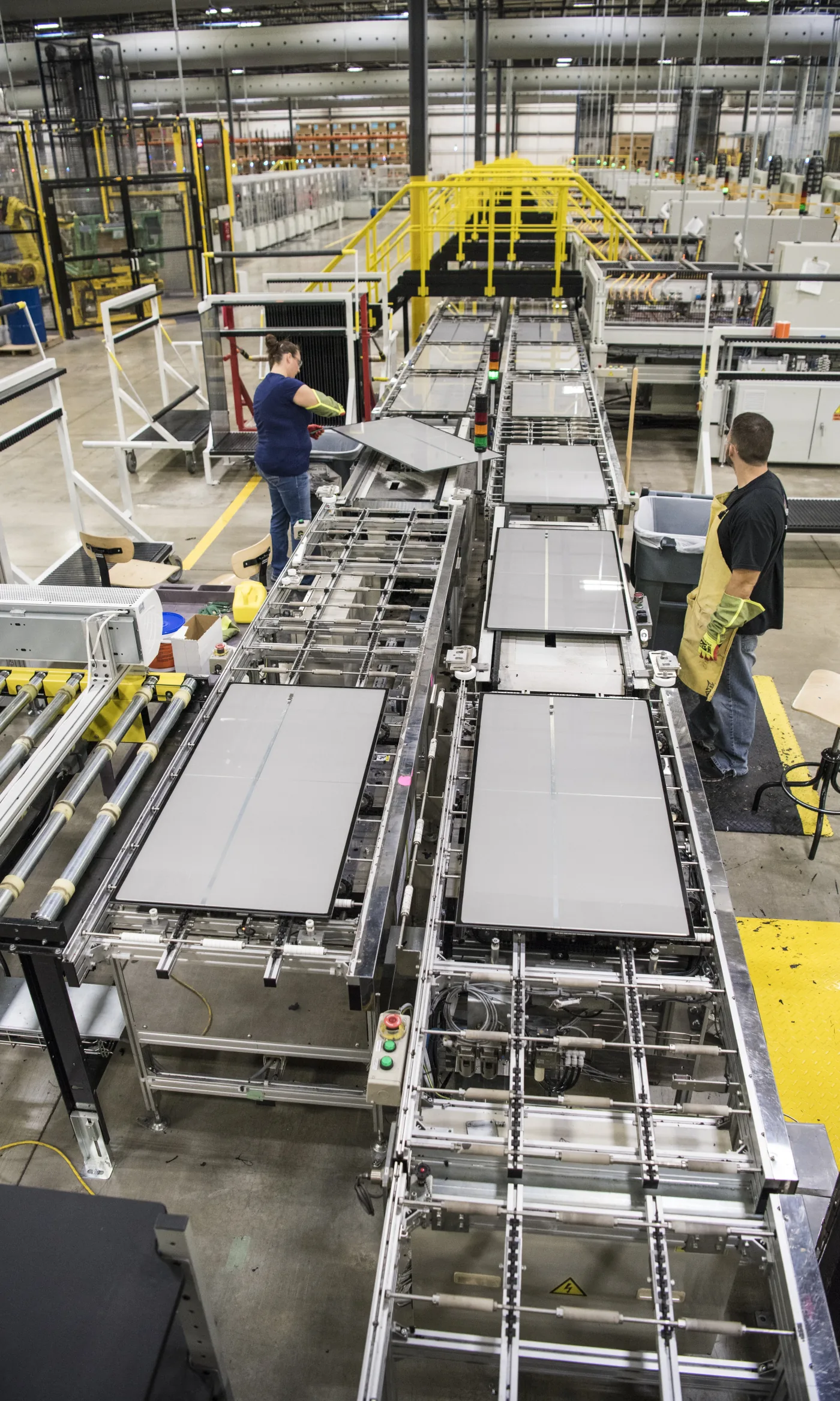 Solar module manufacturing line showing glass-fronted photovoltaic modules
